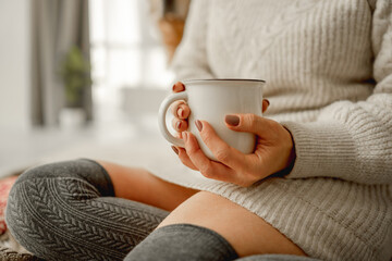 Girl with mug filled with cocoa