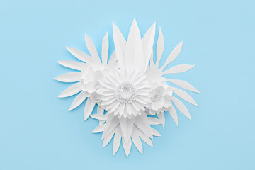 Paper flowers and leaves on blue background