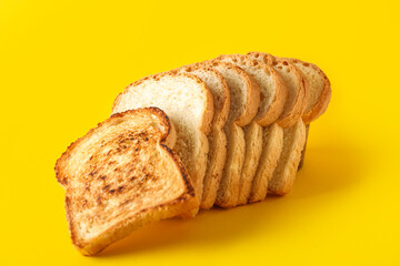 Row of tasty toasts on yellow background