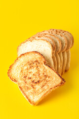Row of tasty toasts on yellow background