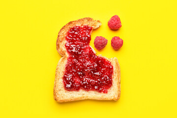 Toast with sweet raspberry jam on yellow background