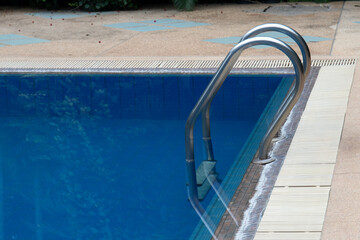 Fototapeta na wymiar Close up Metal Handle of the swimming Pool in a resort