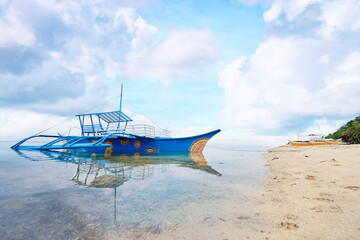 Beautiful landscape with tropical white sand beach with fishing boats. Siargao Island, Philippines.
