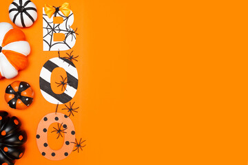 Boo text in halloween style. Pumpkins of different sizes, colors and black spiders on an orange...