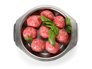 Dish with raw meat balls, parsley and basil on white background