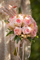 Photo of the bride's wedding bouquet of pink roses.