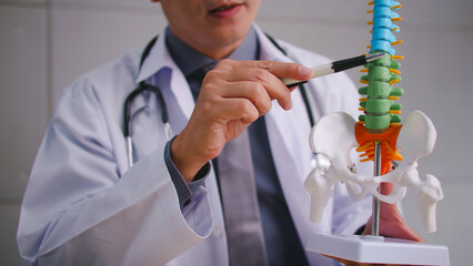 A male doctor explains the physiology of the human body via video call conference.