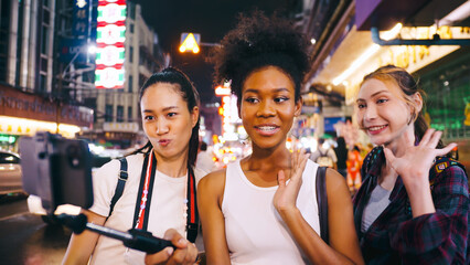 Groups of multi-ethnic female friends are enjoying a night out on Yaowarat Road or Chinatown in Bangkok, Thailand.