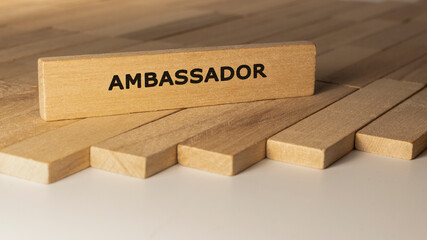 Ambassador written on wooden surface. Concept created from wooden sticks