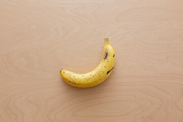 テーブルに置かれた一本のバナナ（皮付き）