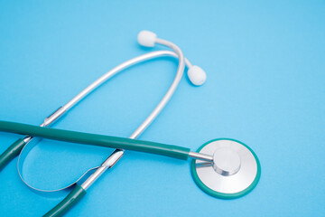 medical stethoscope on blue background with space for text
