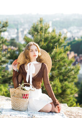 Beautiful girl on the mountain at sunset. Vintage tone. Stylish girl posing on a background of the...