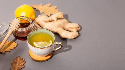  Cup of hot tea with ginger, honey and lemon on the grey background, web banner copy space for text