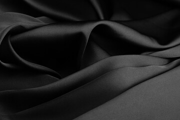 Folds of black silk fabric.