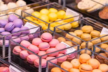 Different types of colorful macarons in the candy store at the Boqueria market in Barcelona (Spain), the name of the sign translated into English means variety of macarons.