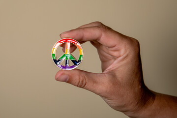 Peace sign in hand, rainbow colors. Love and equality concept