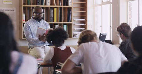 School, education or learning with a teacher reading, studying books and working in notebook in classroom. Knowledge, development and teaching high school teen students work at their desk. - Powered by Adobe