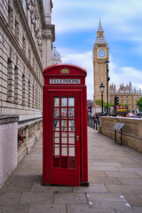 typical phone booth with big ben in the background.