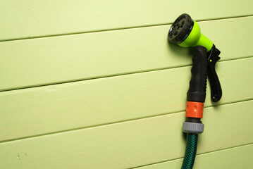 Garden water sprinkler on the green table background with copy space.