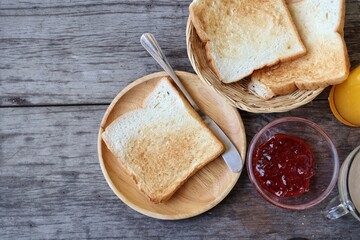 Breakfast of slice toast bread strawberry jam orange juice and coffee cup