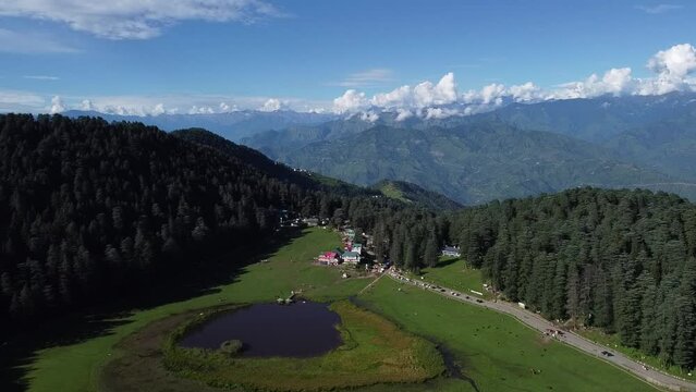 Wide Drone view of Resort in Mountain with Sky and clouds  far to closeup