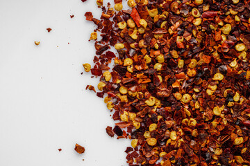 spicy chili flakes on a white background