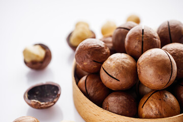 fresh macadamia nuts on a white acrylic background