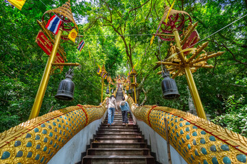 The stairs with a gold serpent statue at Wat Cha Am Khiri, Phetchaburi, Thailand