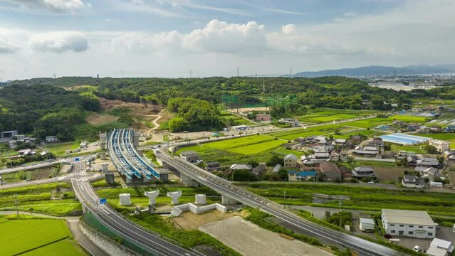 Hyperlapse: Light traffic moves by uncompleted highway overpass in rural area