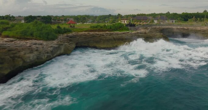 Powerfull waves rolling into tourist spot Devil's tears on rocky coastline of Nusa lembongan