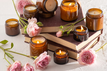 A set of different aroma candles in brown glass jars. Scented handmade candle. Soy candles are burning in a jar. Aromatherapy and relax in spa and home. Fire in brown jar.