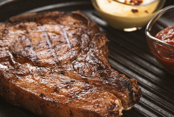 pork steak with vegetables in a black iron pan
