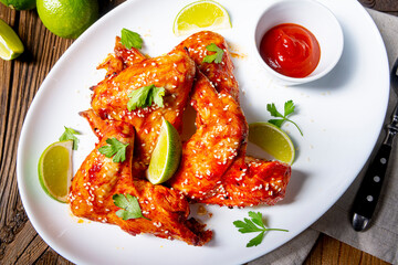 chicken wings with potato wedges and sezam.