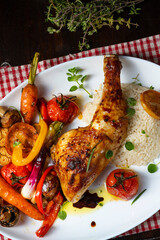 Rustic fried chicken legs with assorted vegetables and rice