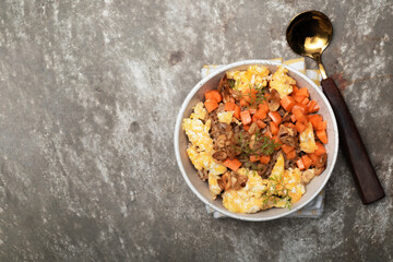 Healthy food garlic fried rice with egg carrot in white bowl on background.