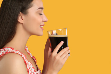 Beautiful woman with cold kvass on yellow background. Traditional Russian summer drink
