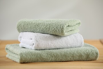 Stack of folded towels on wooden table