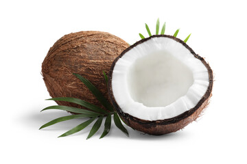Fresh ripe coconuts with green leaves on white background