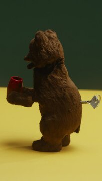 A close up a vintage creepy bear teddy spinning around eating honey