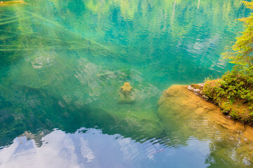 Underwater statue of young girl in Blausee lake (Blue Lake) in Bernese Oberland, Kandergrund, Switzerland
