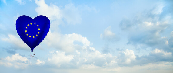 Fototapeta na wymiar European Union flag on balloon against sky clouds background. Education, charity, emigration, travel and learning in EU concept
