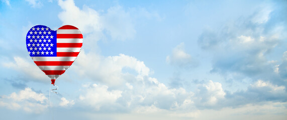 American flag on balloon against sky clouds background. Education, charity, emigration and travel in USA concept