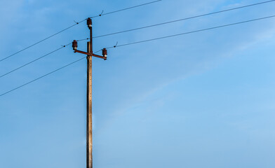 Old electric pole with blue sky