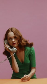 A young ginger white woman, receiving a phone call, then receiving thousands of cash money