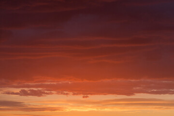 Naklejka na ściany i meble Sunset sky with red and orange clouds