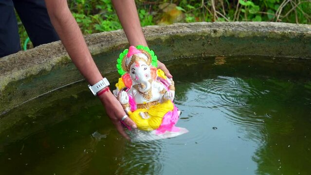 An Indian god Ganesha half immersed in water during Ganesha Chaurthi Festival