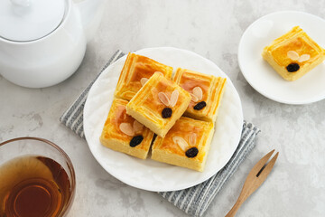 Lekker holland or dutch butter cake (boterkoek), made of butter, flour, eggs and sugar with a sprinkling of sliced ​​almonds and raisins
