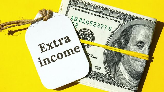 4k zoom in out Dollars cash money and paper note with text written EXTRA INCOME. Concept of financial planning. Make more extra money from parttime side hustle or second job. Startup investment