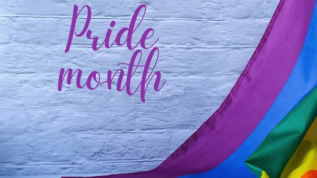 4k zoom in out Rainbow flag with text PRIDE MONTH message. Rainbow lgbtq flag made from silk material. Symbol of LGBTQ pride month. Equal rights. Peace and freedom. Support LGBTQ community