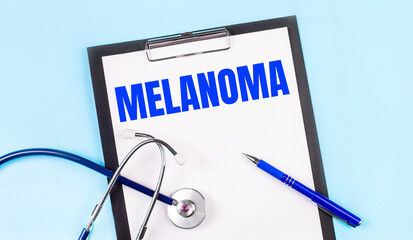 On a blue background, a stethoscope, a pen and a tablet with paper and the text MELANOMA. Medical...